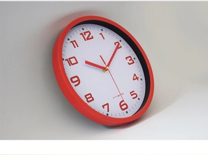 Side view detail of a 10 inch modern red wall clock with gold second hand and bold numbers