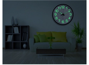 Luminous wall clock with glowing green numerals in a dark modern living room setting