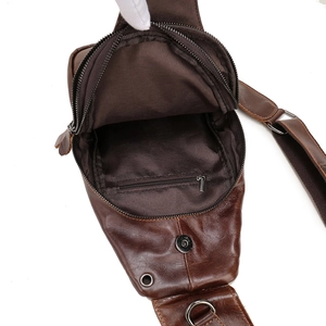 Detailed interior view of dark brown leather chest bag showing large main pocket capacity