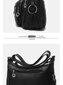 Detail view of black lychee grain leather handbag with silver rings and five-star zippers