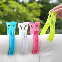 Large windproof plastic clothes clips in four colors fixing quilt on a drying line