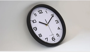 Detail view of the 10-inch minimalist wall clock featuring a matte black frame and 3D profile