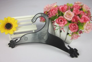 Detail of size S black pet clothes hanger featuring a paw-shaped design and dog logo