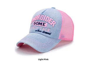 Detail of light pink denim trucker hat featuring white 3D embroidery on front panel