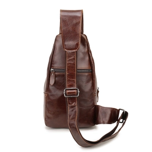 Macro shot of dark brown oil-wax leather texture and metal zipper on men's chest bag