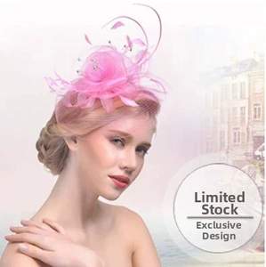 Close-up of pink fascinator with elegant mesh veil feathers and rhinestone floral detail