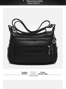 Front view of black soft leather crossbody bag with multiple zippers and star charm