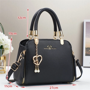 Elegant black lychee leather handbag with heart pendant and gold hardware, 27cm size