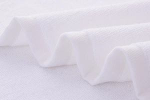 Macro detail of high-quality white cotton towel showing soft looped texture and plush fibers