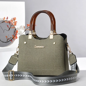 Olive twill tote bag with amber resin handles and wide patterned shoulder strap