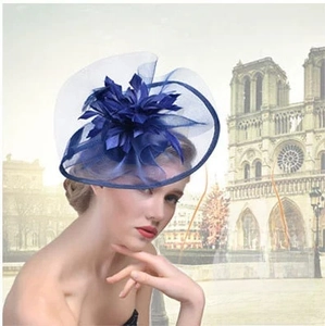 Detail of navy blue fascinator hat with mesh flowers for wedding and formal party
