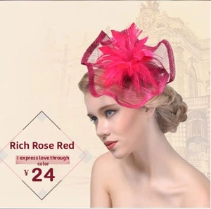 Macro shot of rose red fascinator with feathers and mesh veil for vintage bridal style