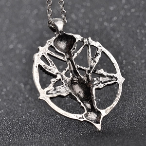 Macro shot of vintage skeleton ram head pendant with textured metallic finish