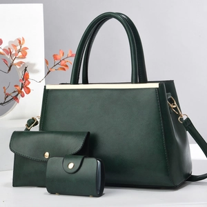 Three-piece dark green handbag set with gold hardware and removable shoulder strap