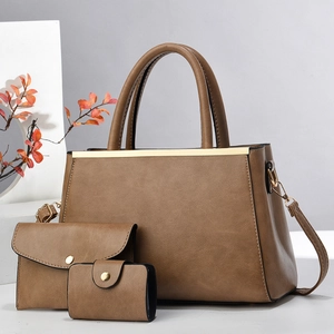 Detailed view of the 3-piece bag set with textured camel brown PU leather and metal trim