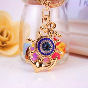 Golden anchor and rudder keychain with blue evil eye crystal rhinestones and swivel clasp