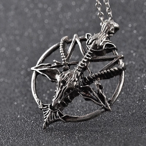 Macro shot of vintage metal Baphomet pendant with goat head and inverted pentagram