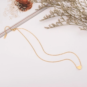 Detail of a gold heart necklace with Lucky engraving and S925 hallmark on the clasp