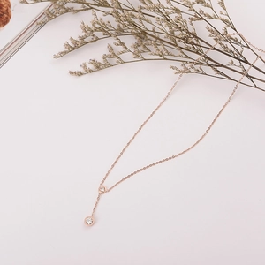 Rose gold necklace with two round clear cubic zirconia stones on a delicate metal chain