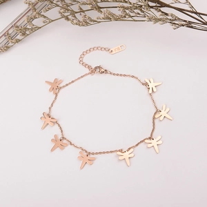 Macro shot of rose gold dragonfly bracelet detailing K18 hallmark on the tag