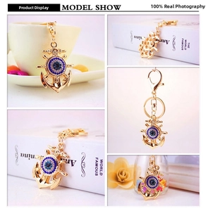 Macro shot of anchor-shaped keychain with crystal evil eye and gold-plated finish