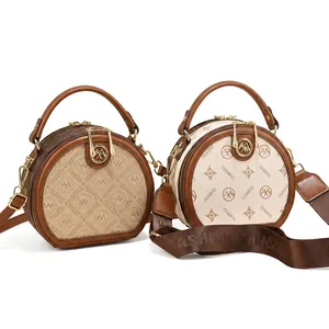 Detail view of round crossbody bags with premium leather texture and patterned straps