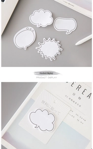 Close-up of cloud and speech bubble sticky notes used as creative memo pads in a book