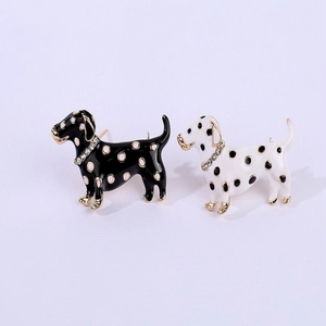 Detail of two enamel Dalmatian dog brooches with sparkling rhinestone collars in black and white