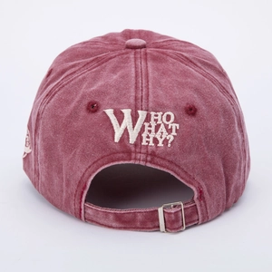 Detail of adjustable metal buckle and WHO WHAT WHY embroidery on washed burgundy baseball cap