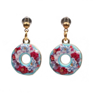 Macro shot of colorful floral enamel patterns on circular hoop earrings with ear hooks