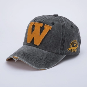 Close-up of distressed brim and orange W patch on washed grey cotton baseball cap
