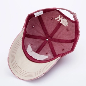 Detail of army green washed baseball cap showing interior stitching and material tags