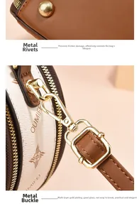 Detail of the golden metal studs and detachable swivel hook on the brown leather bag