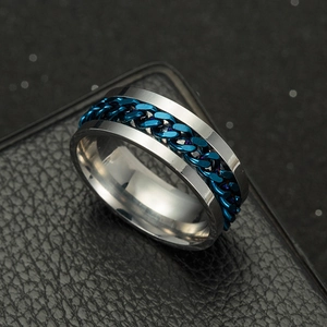Close-up of titanium steel spinner ring with a blue Cuban chain inlay and polished edges