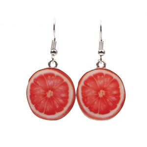 Detail view of grapefruit slice earrings with realistic texture and metal hooks