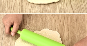 Close-up of hands using a 30.5cm green silicone non-stick rolling pin on dough