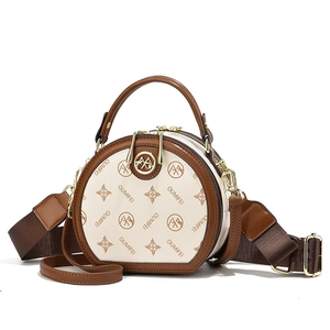 Chic round beige PU leather crossbody bag with brown trim and dual shoulder straps
