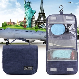 Hanging travel wash bag in navy blue with multi-layered compartments and top hook