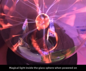 Close-up of a 3-inch plasma ball lamp with purple lightning beams and black base