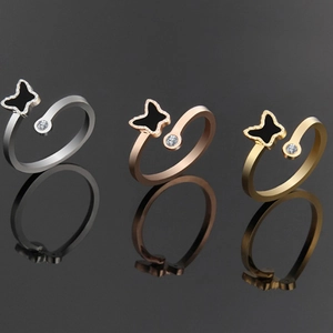 Detailed view of adjustable butterfly rings in silver, rose gold, and gold plating