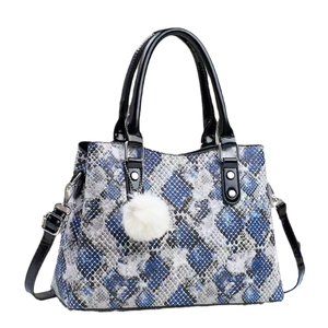 Blue and gray snake pattern handbag with black patent handles and a white pompom charm