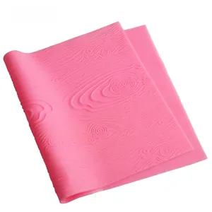 Detail view of pink silicone mold featuring a realistic textured wood bark pattern design