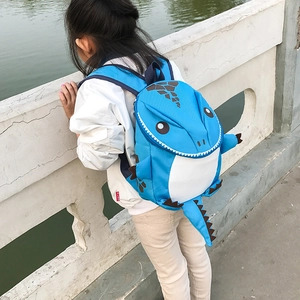 Detail shot of 3D dinosaur kid backpack with blue fabric and white spikes