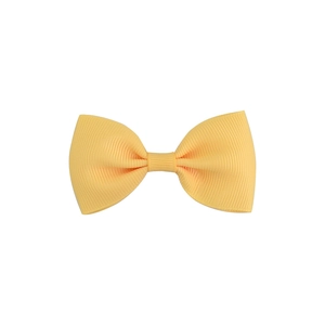 Detailed view of yellow grosgrain ribbon bow hairclip with distinct ribbed texture