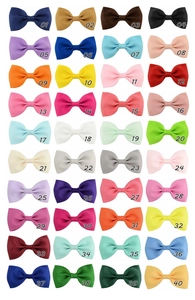 Collection of 40 colorful grosgrain ribbon bow clips for girls in a grid display