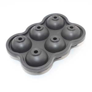 Detail of black 6-cavity silicone ice sphere mold for round ice balls on white background