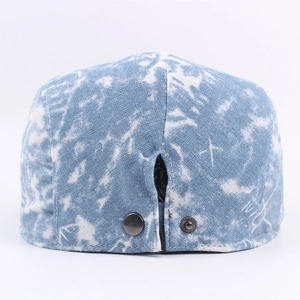 Blue and white washed denim flat cap with adjustable metal snap buttons on the back view