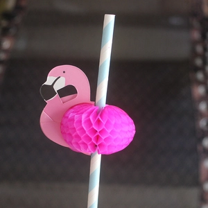 Close-up of a blue striped paper straw featuring a 3D pink flamingo honeycomb craft