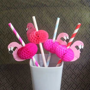 Detail showing flamingo honeycomb straws with pink and blue stripes for party decoration