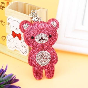 Close-up of pink rhinestone teddy bear keychain with silver tassels and metal hook